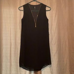 Zip front black dress.